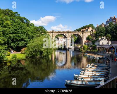 Rowing boats below the railway viaduct spanning the River Nidd valley at Knaresborough North Yorkshire England Stock Photo