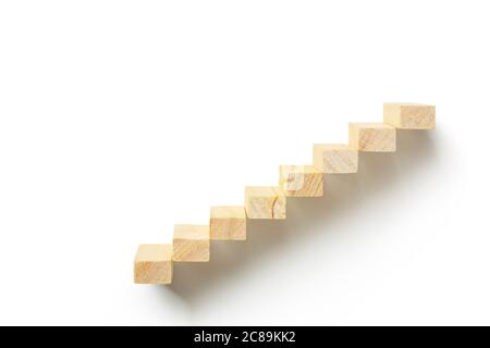 wooden toy blocks as staircase on white, abstract concept Stock Photo