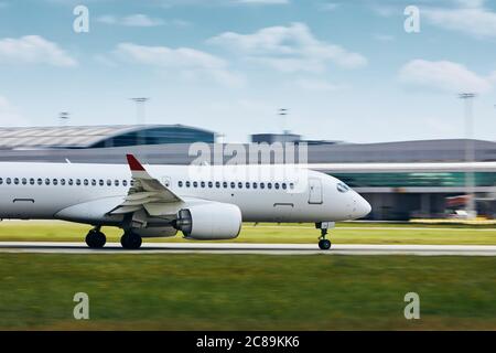 Passenger airplane accelerates on airport runway for take off. Stock Photo