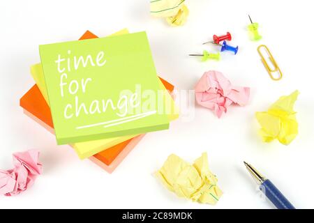 time for change on adhesive notes with crumpled paper and pen on white Stock Photo