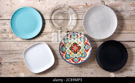 Set of different empty plates on wooden background Stock Photo