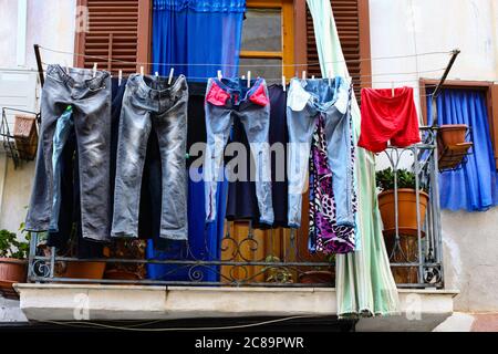 Jeans Hanging on Balcony in Lisbon Portugal Stock Photo