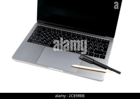 Top view white office desk table with computer laptop keyboard, pen and pencil. Office supplies isolated on white background with copy space Stock Photo