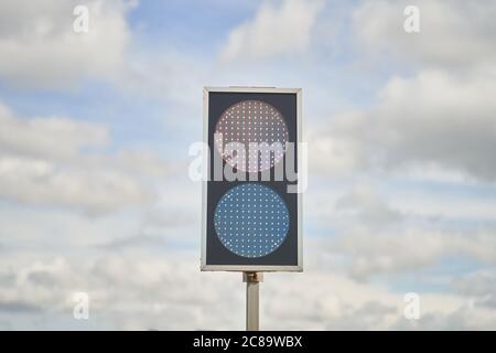 Traffic light with two colors on a blue sky background