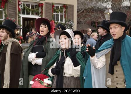 ST. CHARLES, UNITED STATES - Dec 23, 2008: Dickens-era Christmas carolers performing on a street corner in St. Charles, Missouri Stock Photo