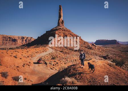 A woman with a child and a dog Is standing on a hill, Valley of Gods