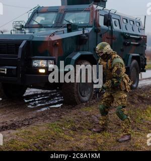 Ukraine modern soldier moves undercover armored car Stock Photo