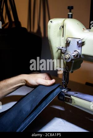 craftsman working with leather and sewing machine Stock Photo