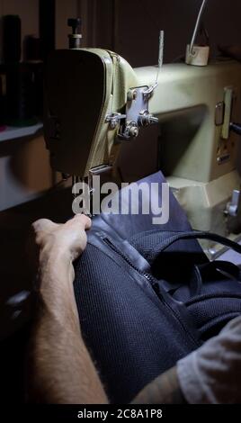 craftsman working with leather and sewing machine Stock Photo