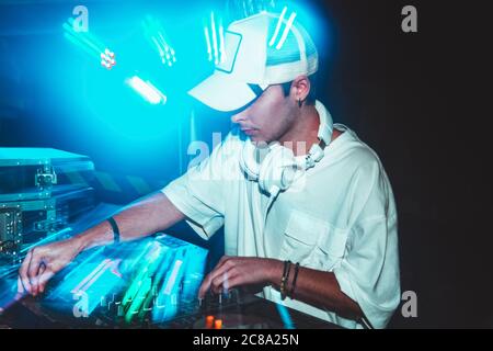 Dj mixes the track in the nightclub at party Stock Photo