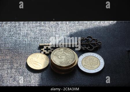 Vintage key and gold coins. Black copyspace on the top. Keys to success motivation achievement business concept Stock Photo