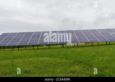 Photovoltaic solar power panel on sky background, green clean alternative energy concept Stock Photo