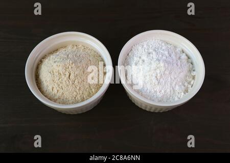 Bowl of Whole wheat Flour and A Bowl of White Flour Isolated on Dark Brown Wooden Table Stock Photo