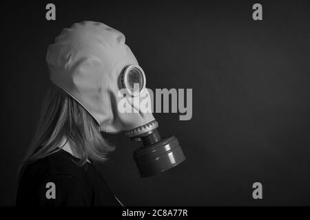 The girl in a gas mask on a black background, close up, black and white. Your text here, copy space Stock Photo