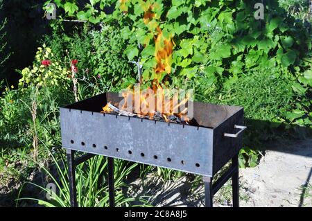 Brazier with burning charcoal for cooking kebabs, grilling. Stock Photo