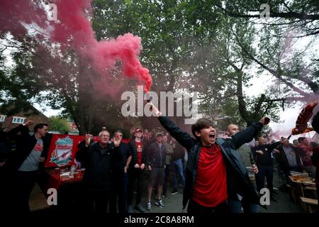 Liverpool fans with flares celebrate their sides second goal during their match against Chelsea. Stock Photo