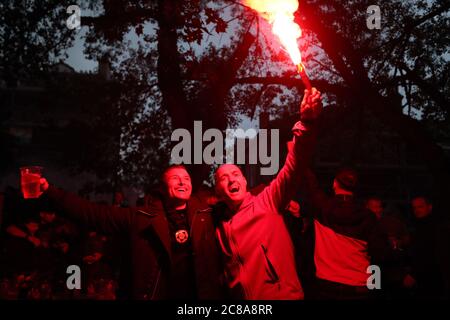 Liverpool fans with flares celebrate their sides second goal during their match against Chelsea. Stock Photo