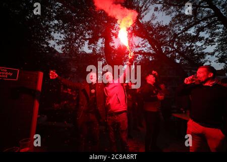 Liverpool fans with flares celebrate their sides second goal during their match against Chelsea. Stock Photo