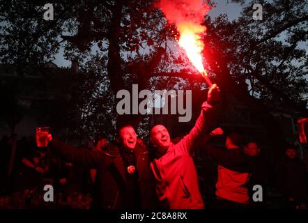 Liverpool fans with flares celebrate their sides second goal during their match against Chelsea. Stock Photo