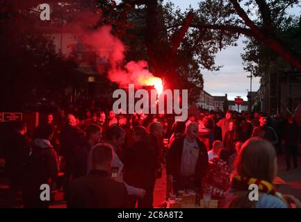 Liverpool fans with flares celebrate their sides second goal during their match against Chelsea. Stock Photo