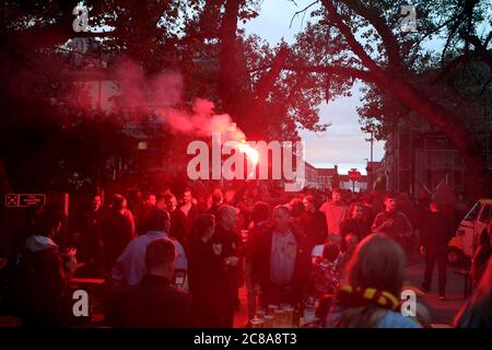 Liverpool fans with flares celebrate their sides second goal during their match against Chelsea. Stock Photo