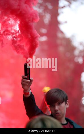 Liverpool fans with flares celebrate their sides second goal during their match against Chelsea. Stock Photo