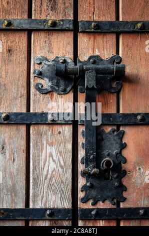 ancient medieval castle door with iron knocker and lock Stock Photo