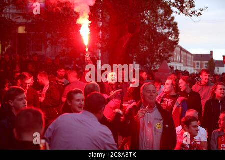 Liverpool fans with flares celebrate their sides second goal during their match against Chelsea. Stock Photo