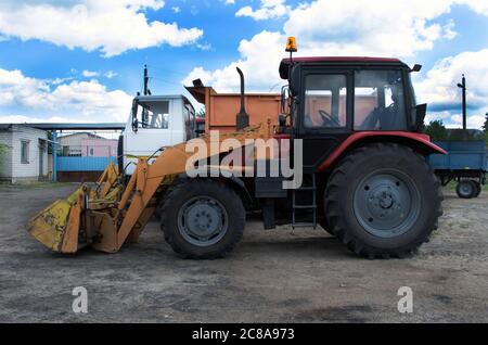 Old rusty tractor's flat back tire. Stock Photo