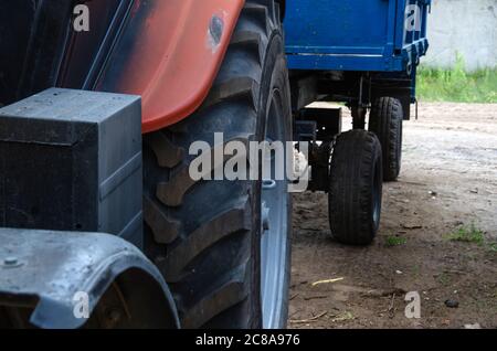 Old rusty tractor's flat back tire. Stock Photo