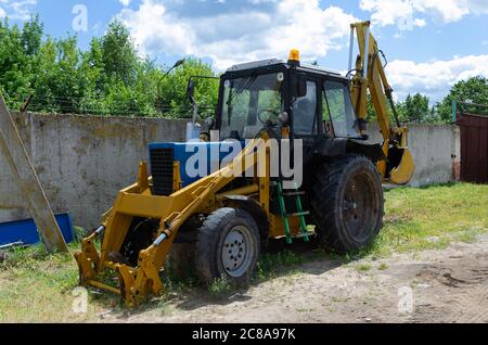 Old rusty tractor's flat back tire. Stock Photo