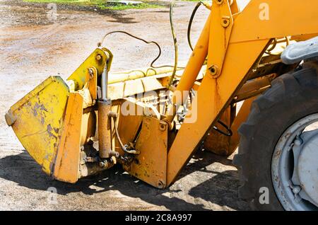 Old rusty tractor's flat back tire. Stock Photo