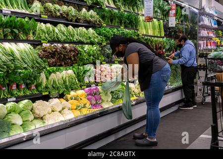 Workers in the produce department in the new Whole Foods Manhattan West in the Hudson Yards neighborhood of New York on opening day, Friday, July 17, 2020. (© Richard B. Levine) Stock Photo