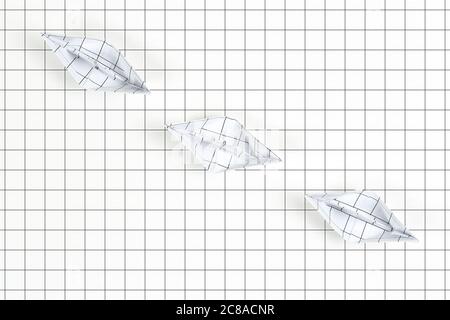 top view of three paper boats on white paper surface with squares Stock Photo
