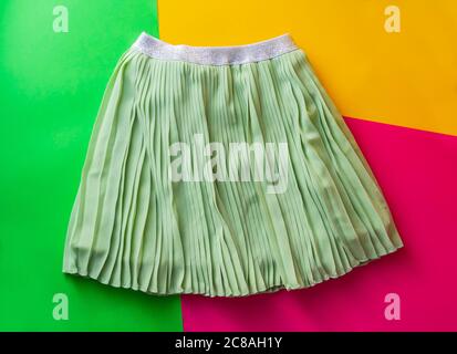 Top view fashion trendy look of girls clothes and shoes, fashion concept, outfit, colors background, Stylish child look. Stock Photo