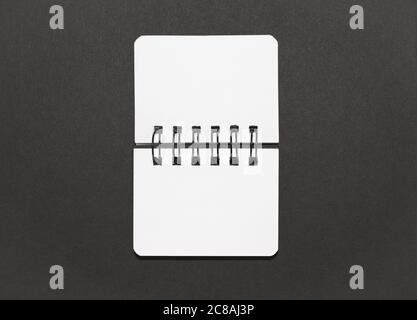 Open notebook on a black background, minimal design Stock Photo