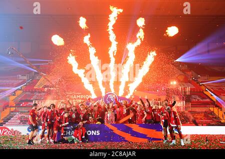 Liverpool players celebrate with the Premier League trophy after the Premier League match at Anfield, Liverpool. Stock Photo