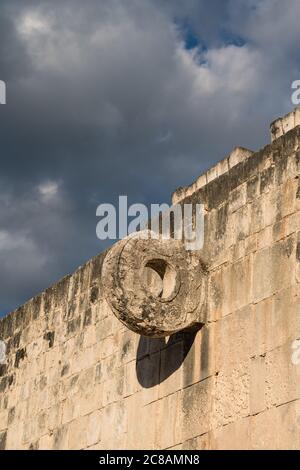 The carved stone ring set high in the wall of the Great Ball Court in the ruins of the great  Mayan city of Chichen Itza, Yucatan, Mexico.  The Pre-Hi Stock Photo