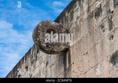 The carved stone ring set high in the wall of the Great Ball Court in the ruins of the great  Mayan city of Chichen Itza, Yucatan, Mexico.  The Pre-Hi Stock Photo