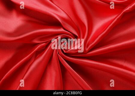 luxurious red satin fabric, abstract swirls and folds Stock Photo