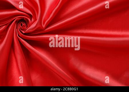 luxurious red satin fabric, abstract swirls and folds Stock Photo