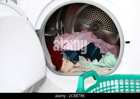 view clothes inside dryer with open door Stock Photo