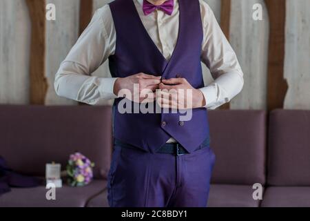 a male businessman putting on blue suit Stock Photo