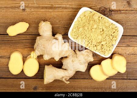 ginger root and powder on old wooden table Stock Photo
