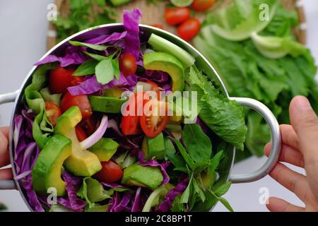 Vietnamese vegetarian cuisine, mixed vegetable from avocado, salad, tomato, violet cabbage with soy sauce, lemon, chili, nutrition vegan dish Stock Photo