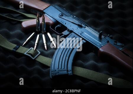 Famous Russia's assault rifle Kalashnikov AK-47 with a couple of rounds Stock Photo