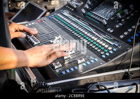 Hand adjusting on a professional audio mixer Stock Photo