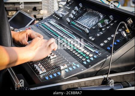 Hand adjusting on a professional audio mixer Stock Photo
