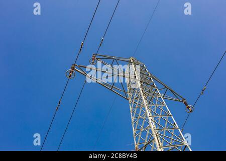 Electricity transmission power. High voltage tower with wires on blur sky background. Industrial energy Stock Photo