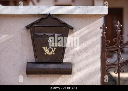 Brown mailbox on brick wall, vintage mailbox style. Stock Photo